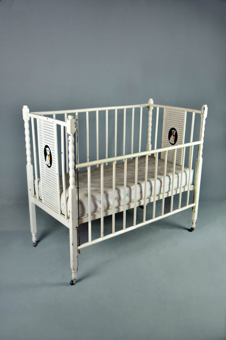 Child`s painted cot with drop down sides, bergere decorated ends with